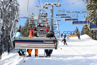 Skiers go on the lift on mountain