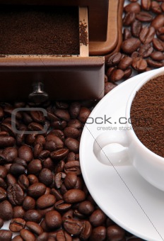 Fragment of a cup with ground coffee and coffee beens