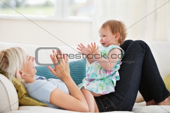 Attractive mother playing with her daughter