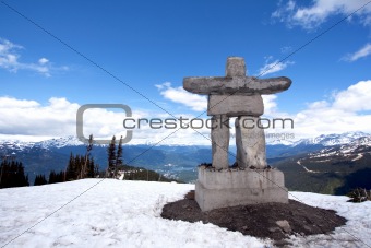 Whistler Peak inukshuk with snow and mountains