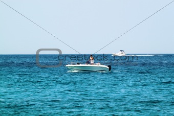 A white speedboat on open sea