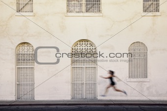 Fast running woman on a city street.