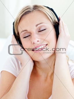 Radiant young woman listen to music wearing headphones 