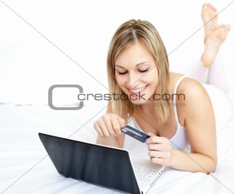 Sexy woman lying with a laptop on sofa