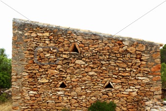 masonry stone wall triangle windows Formentera