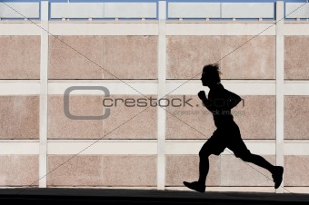 Physically fit man runs for exercise