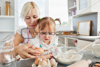 Focused woman baking cookies with her daughter