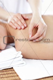 Close-up of a young woman receiving a acupuncture treatment 