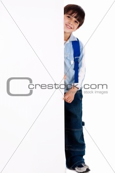 Young kid standing behind the board