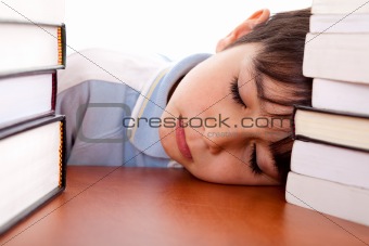 School boy sleeping on table