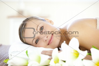 Charming woman lying on a massage table looking at the camera 