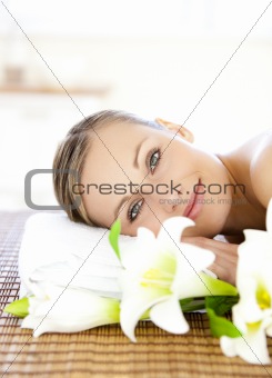 Portrait of a charming woman lying on a massage table smiling at