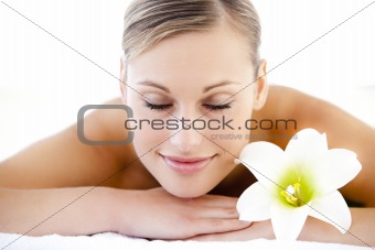 Close-up of a resting woman lying on a massage table with a flow
