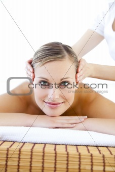 Happy young woman receiving a head massage 