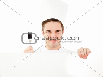 Happy young man holding a fork and a placard 