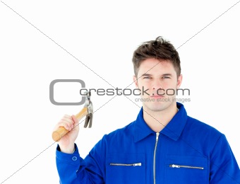 Serious worker holding a hammer looking at the camera 