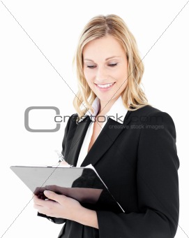 Ambitious young businesswoman taking notes on her clipboars 