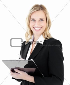 Glowing young businesswoman taking notes on her clipboars 