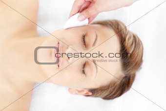 Positive young woman receiving a beauty treatment 