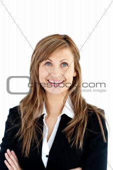 Cheerful businesswoman with folded arms looking upwards
