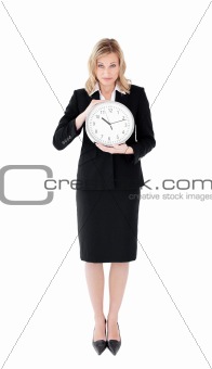 Distressed businesswoman holding a clock 