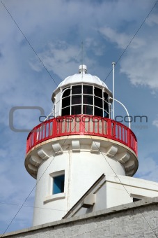 lighthouse isolated against clouds