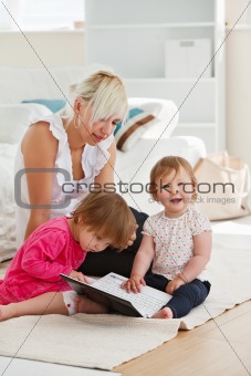 Laughing little girl using a laptop with her family 