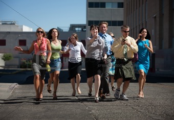 Young business workers run down steet.