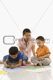 Boys coloring with mother.