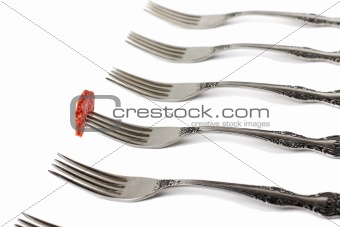 Forks and piece of sausage