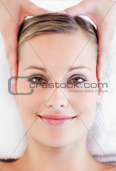 Young smiling woman receiving a head massage