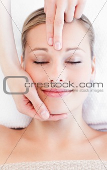 Young bright woman receiving a head massage