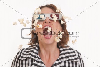 Front view portrait of young woman with 3D glasses and popcorn in the air