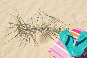 Beach grass towel and flip-flops.