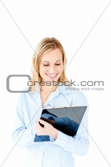 Glowing young businesswoman taking notes on her clipboard
