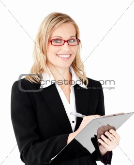 Charming businesswoman writing on a clipboard 