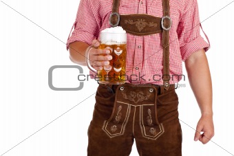 Bavarian man with leather trousers (Lederhose) holds Oktoberfest beer stein