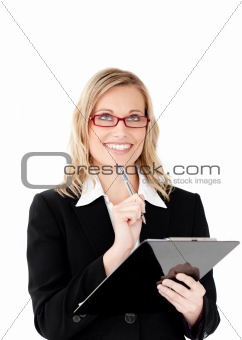 Thoughtful businesswoman holding a clipboard 