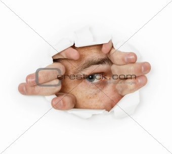 Man looks through a hole in paper