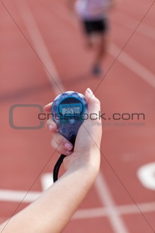 Close-up of a woman holding a chronometer to measure performance