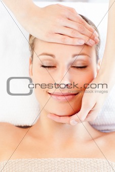 Young caucasian woman receiving a head massage