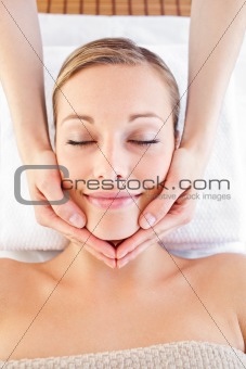 Happy woman receiving a head massage