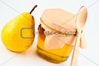 Honey in jar and pear.