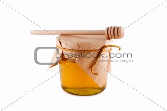 Honey in jar wooden spoon isolated white.