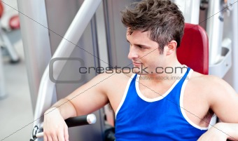 Relaxed young man using a bench press