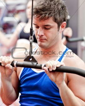 Beautiful male athlete practicing body-building