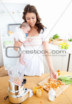 Caring young mother preparing vegetables for her baby in the kit