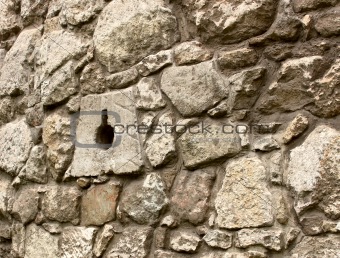 Ancient stone wall with loopholes