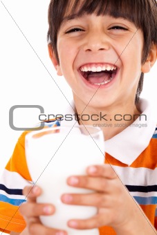 Smiling young boy holding a glass of milk 