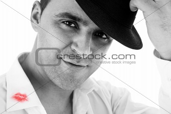 seductive man greeting with his hat and shirt with lipstick mark